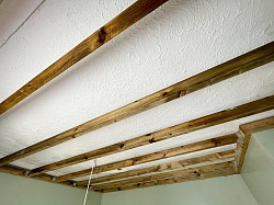 Timber suspended ceiling below Artex ceiling in poor condition